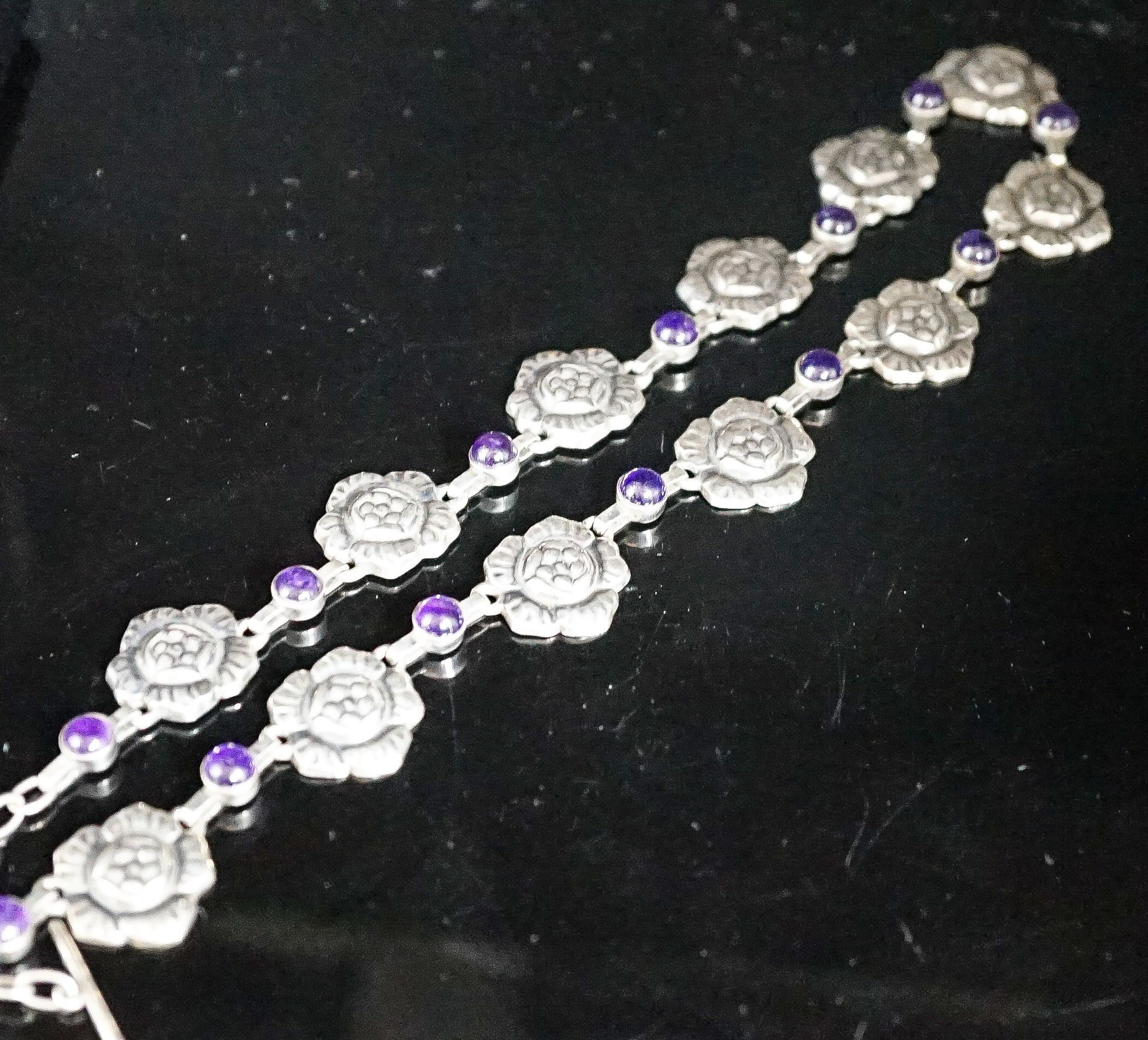 A Georg Jensen sterling flower head and cabochon amethyst link necklace, set with twelve stones. no. 5, approx. 42cm.